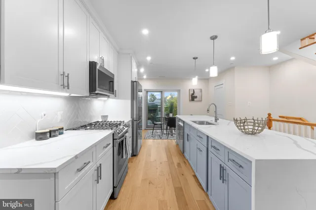 a kitchen with a sink stove and cabinets