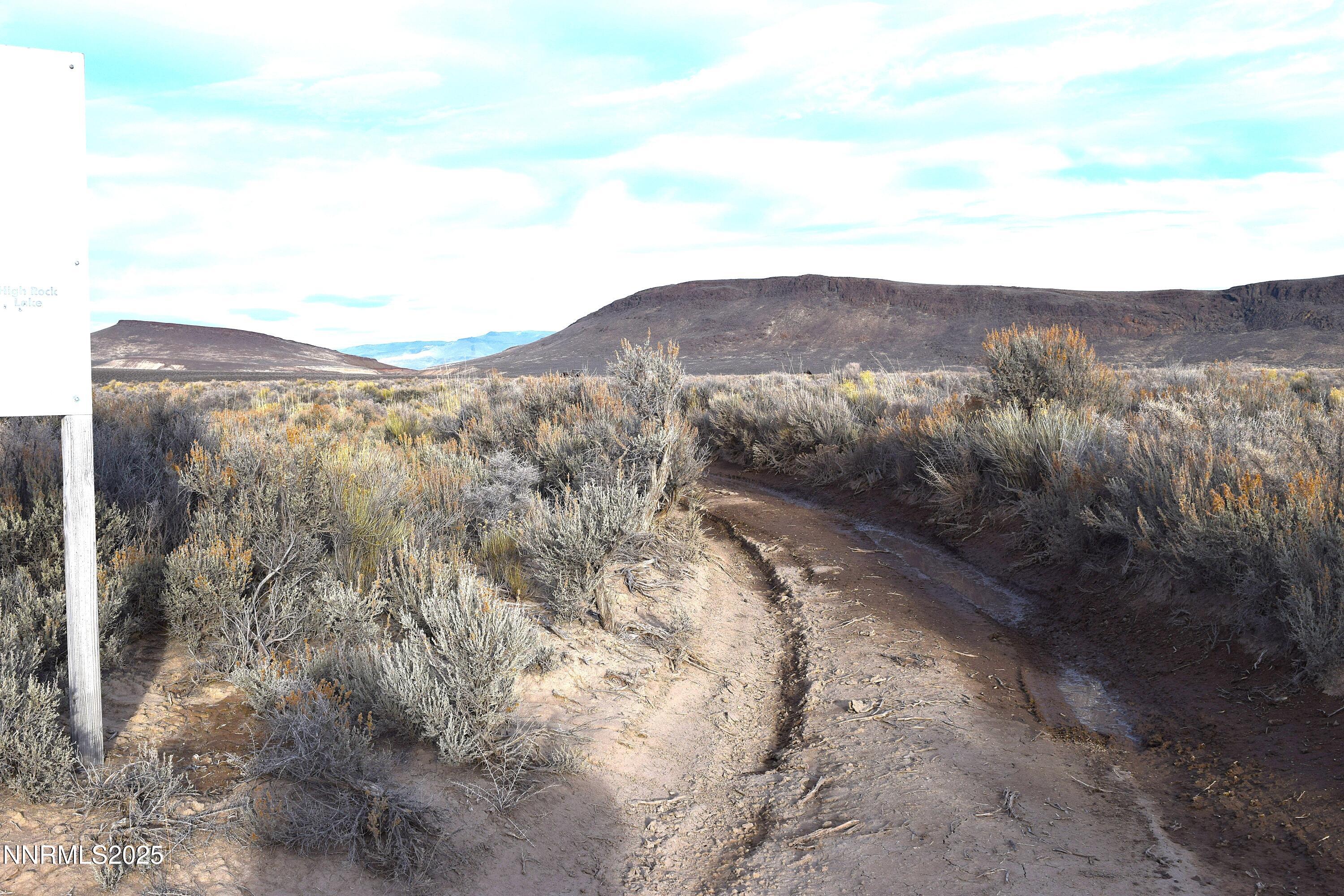 3307-3308 High Rock Road Reno, NV 89510 - Photo 13 of 39 a view of a dry yard with mountains in the background