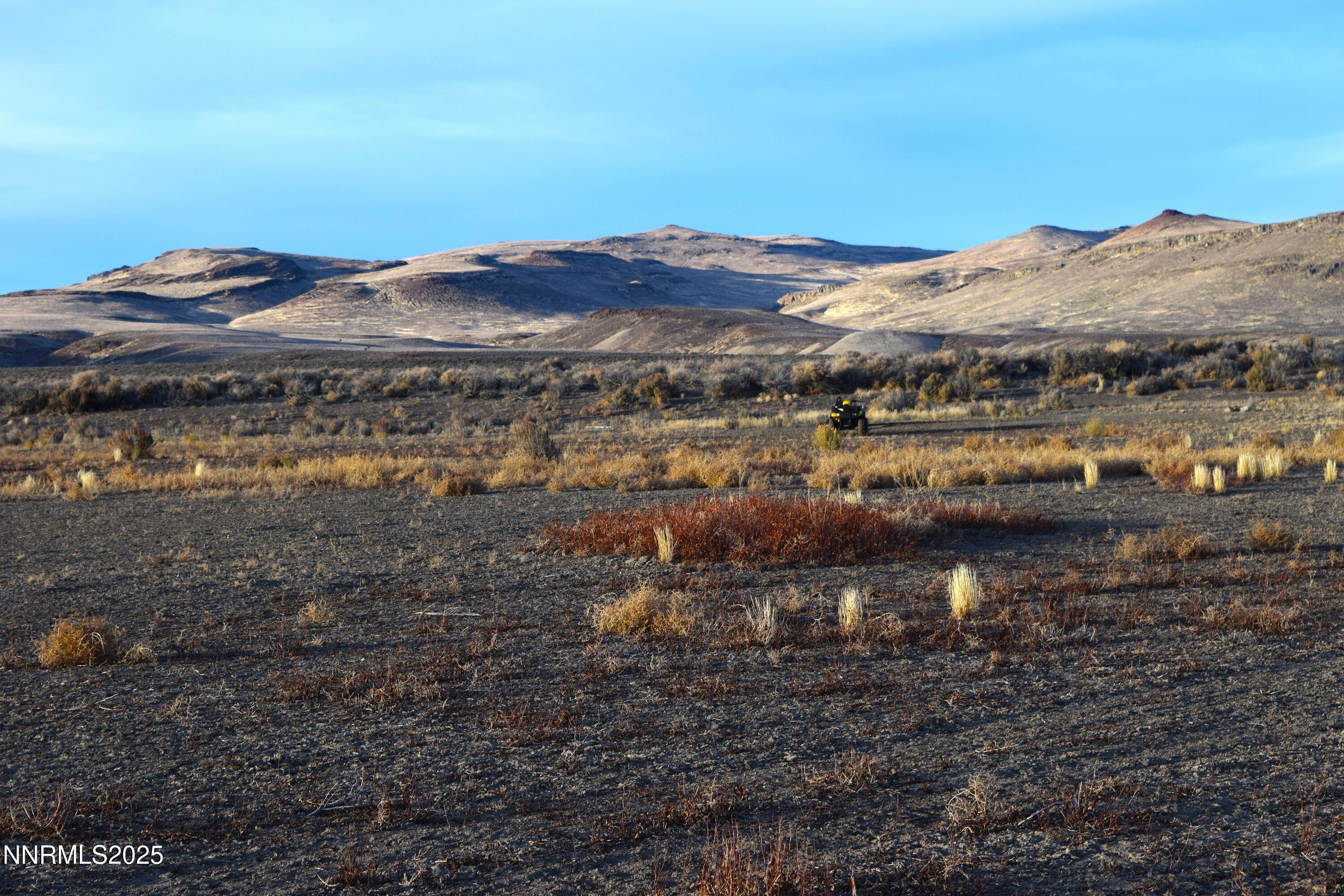 3307-3308 High Rock Road Reno, NV 89510 - Photo 28 of 39 a view of a lake with mountains in the background