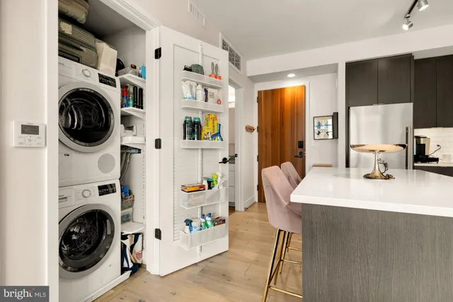 a living room with furniture a flat screen tv and a view of kitchen