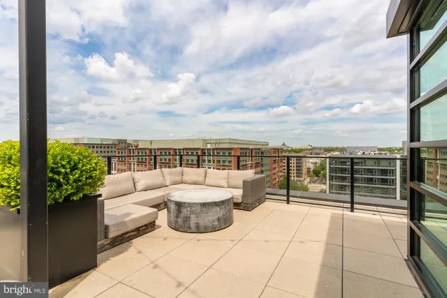 a view of a terrace with chairs and iron fence