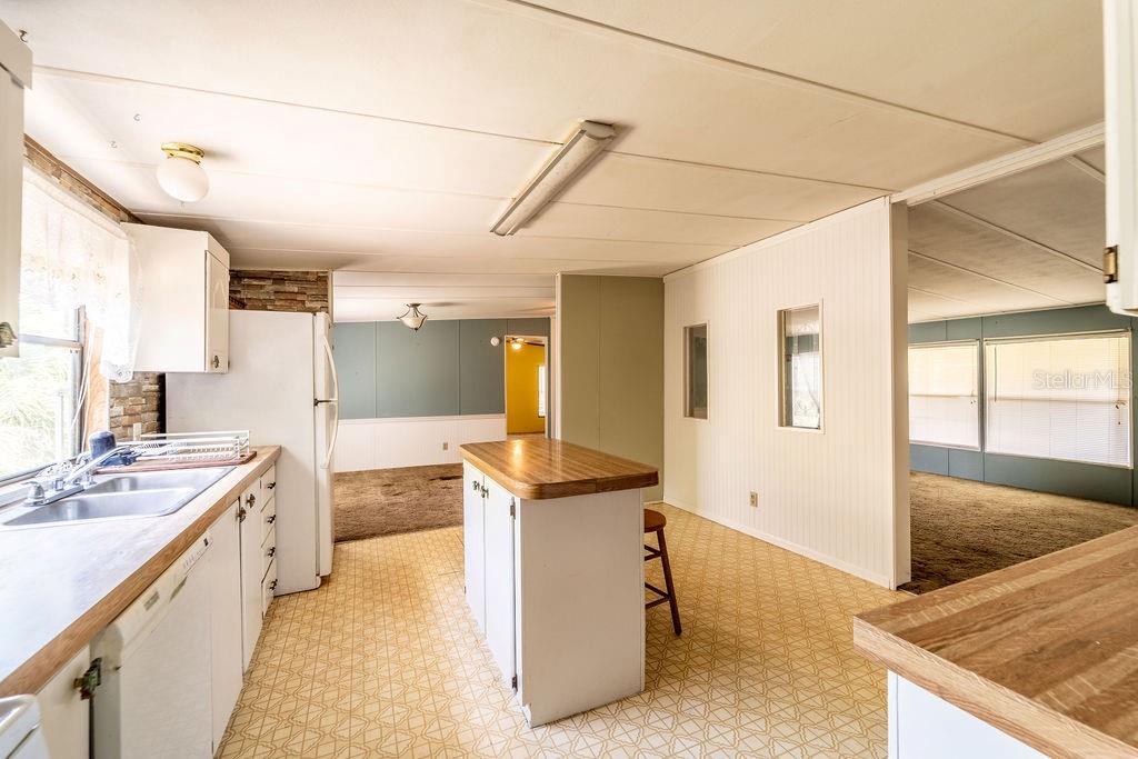 24031 Armadillo Road Astor, FL 32102 - Photo 16 of 43 a kitchen with stainless steel appliances granite countertop a sink and cabinets