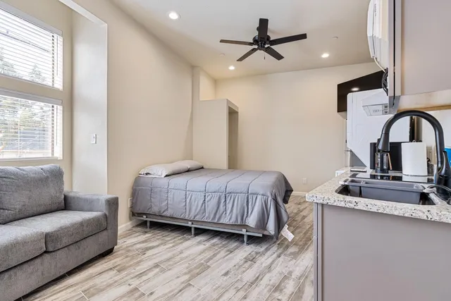 a bedroom with a bed couch and window