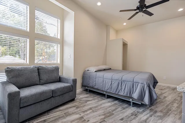 a bedroom with a bed couch and window