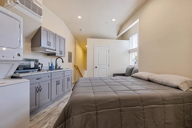 a bedroom with a bed and a sink