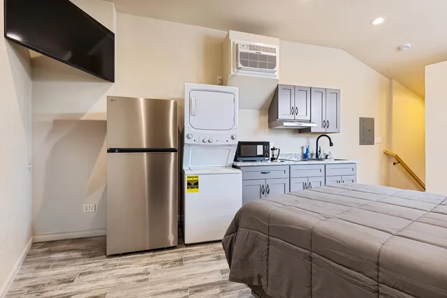a bedroom with a bed dresser and a window