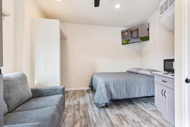 a bedroom with a bed and a couch