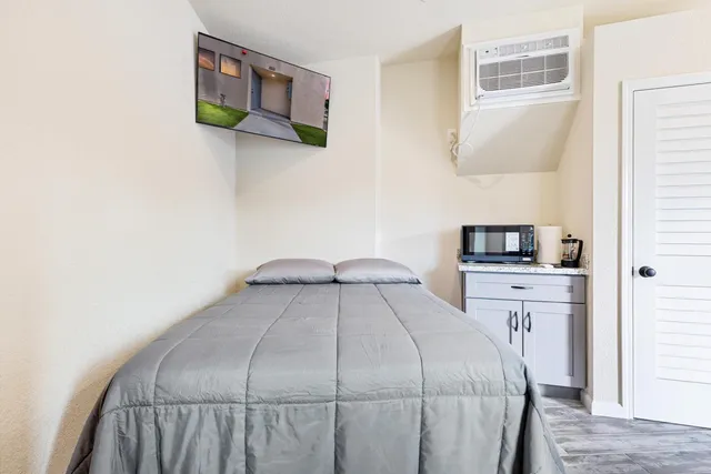 a bedroom with a bed and a cabinets