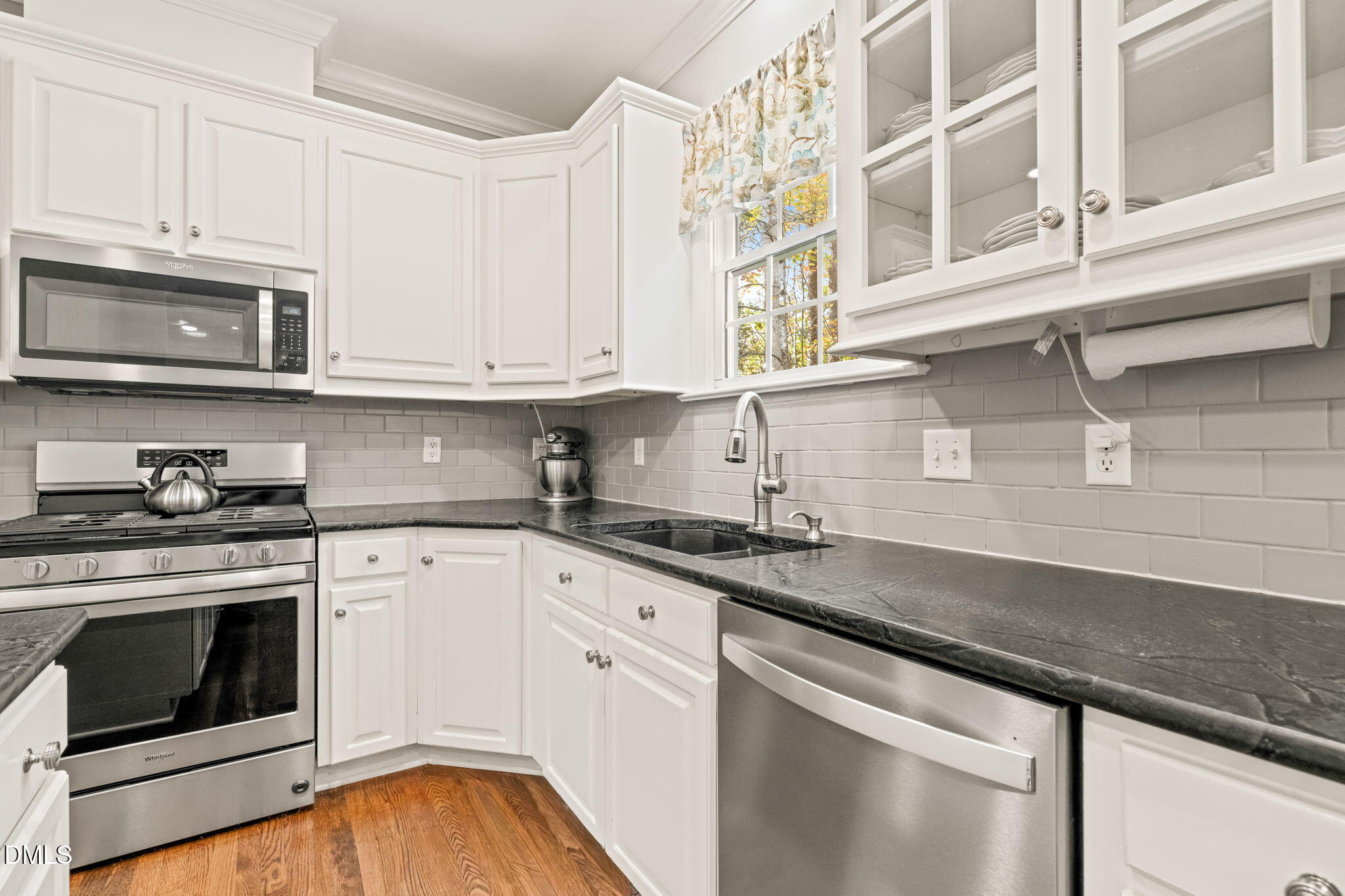 5504 Orchid Hill Drive Raleigh, NC 27613 - Photo 10 of 46 a kitchen with stainless steel appliances granite countertop a sink a stove and cabinets