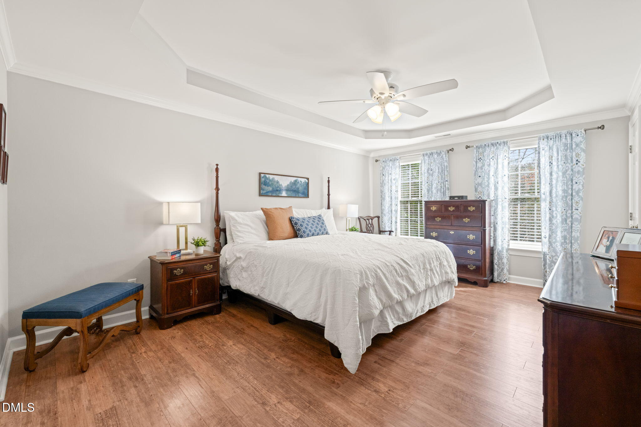5504 Orchid Hill Drive Raleigh, NC 27613 - Photo 16 of 46 a bedroom with a bed and wooden floor
