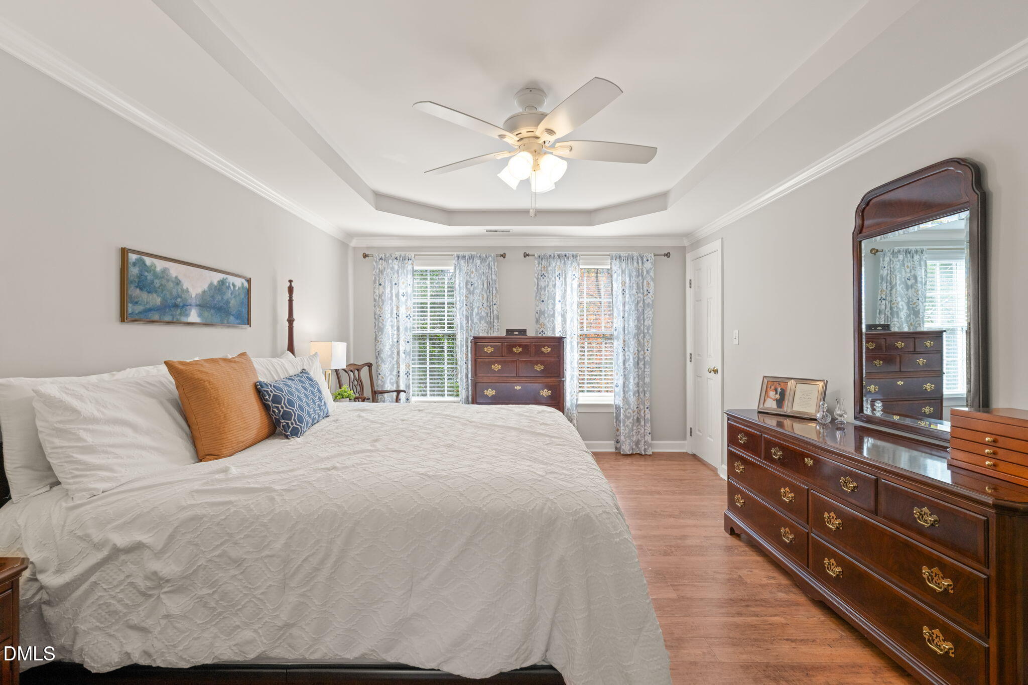 5504 Orchid Hill Drive Raleigh, NC 27613 - Photo 17 of 46 a bedroom with a bed and a dresser
