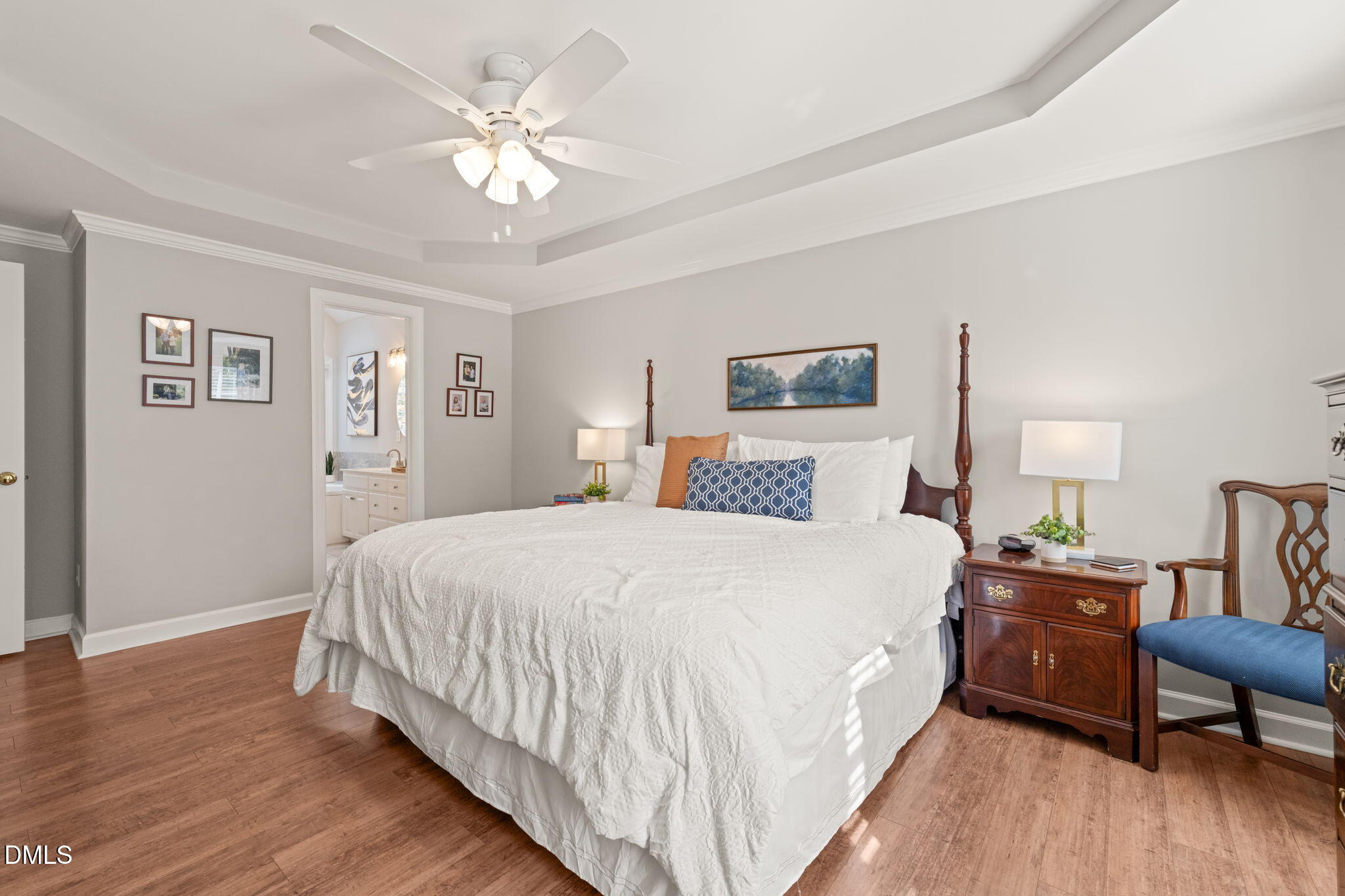 5504 Orchid Hill Drive Raleigh, NC 27613 - Photo 18 of 46 a bedroom with bed and a chandelier