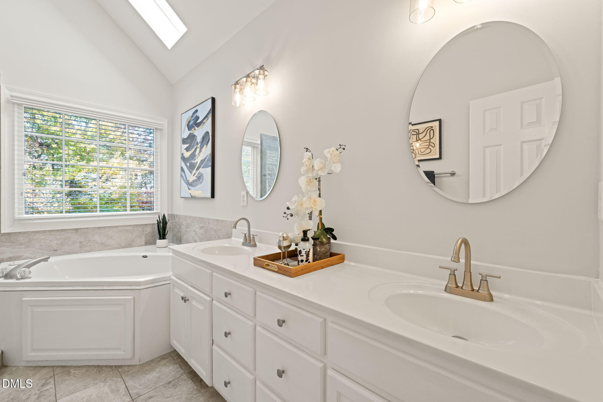 5504 Orchid Hill Drive Raleigh, NC 27613 - Photo 19 of 46 a bathroom with a double vanity sink and a bathtub