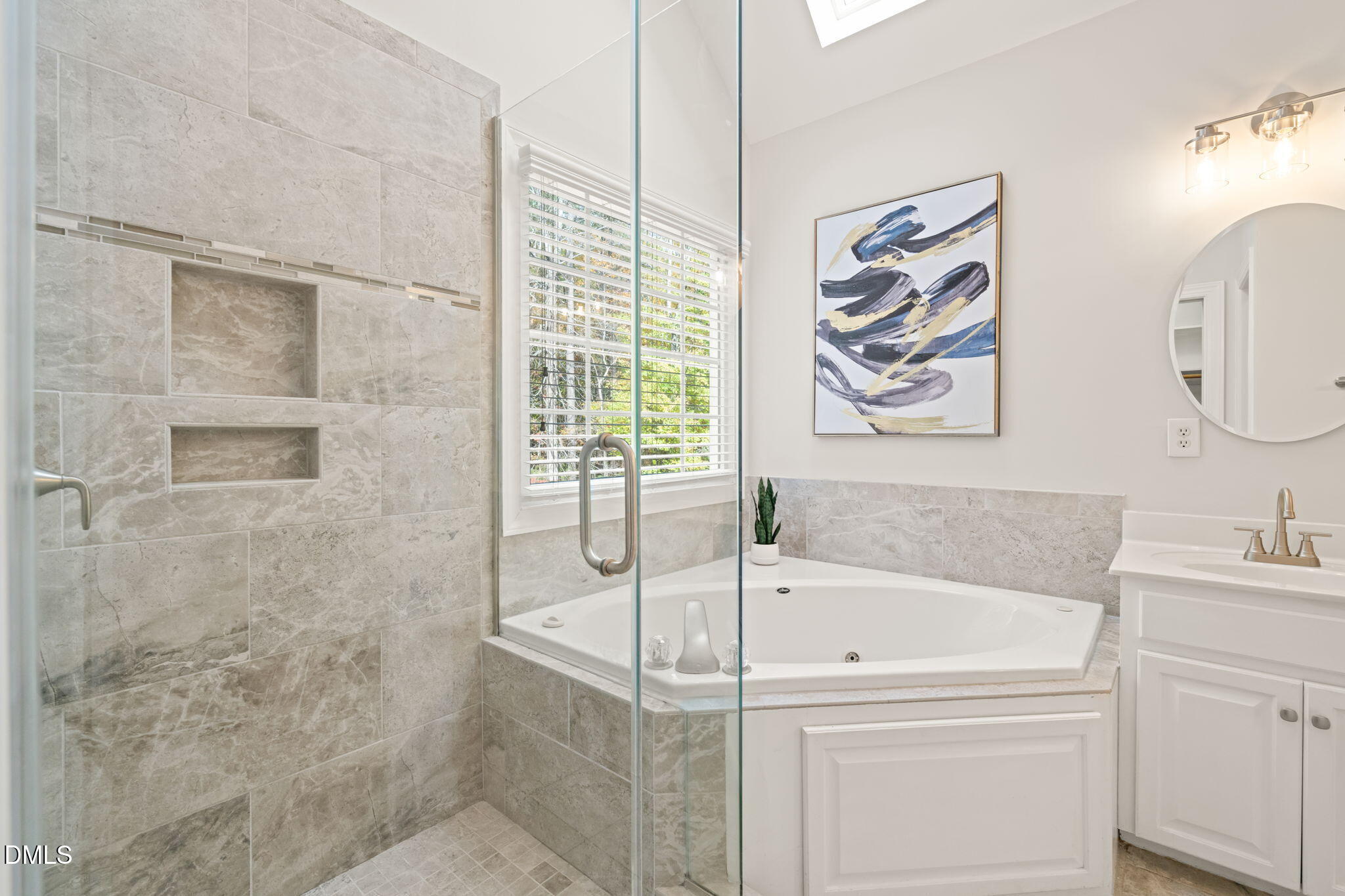 5504 Orchid Hill Drive Raleigh, NC 27613 - Photo 20 of 46 a white bath tub sitting next to a white sink and vanity