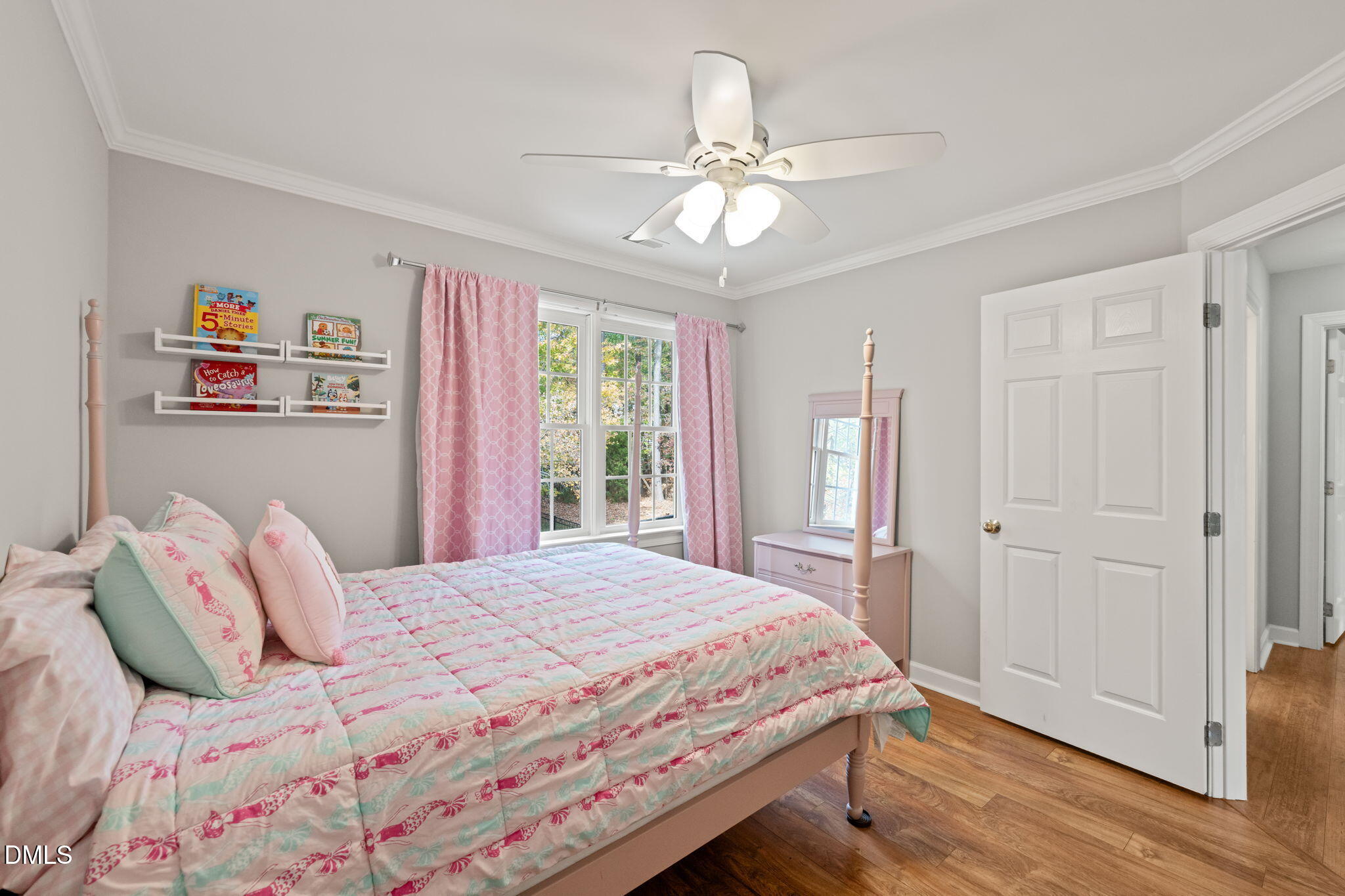 5504 Orchid Hill Drive Raleigh, NC 27613 - Photo 25 of 46 a bedroom with a bed and a chandelier
