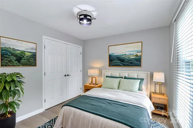 a bedroom with a bed and a potted plant