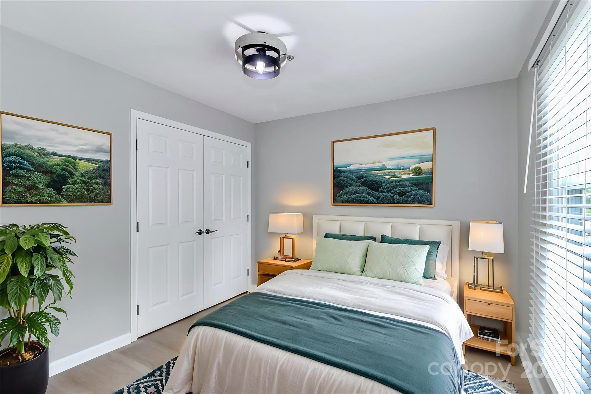 18563 Vineyard Point Lane Cornelius, NC 28031 - Photo 12 of 23 a bedroom with a bed and a potted plant