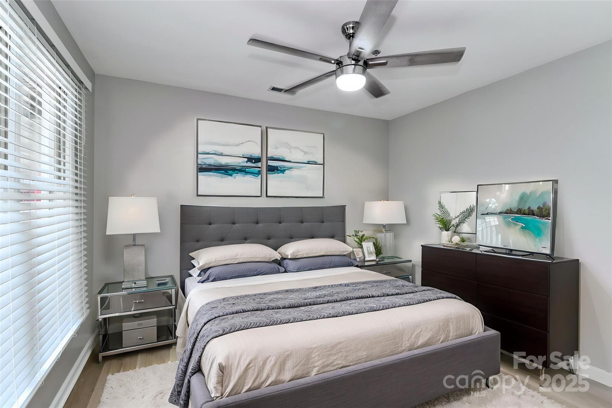 18563 Vineyard Point Lane Cornelius, NC 28031 - Photo 13 of 23 a bedroom with a bed and a chandelier