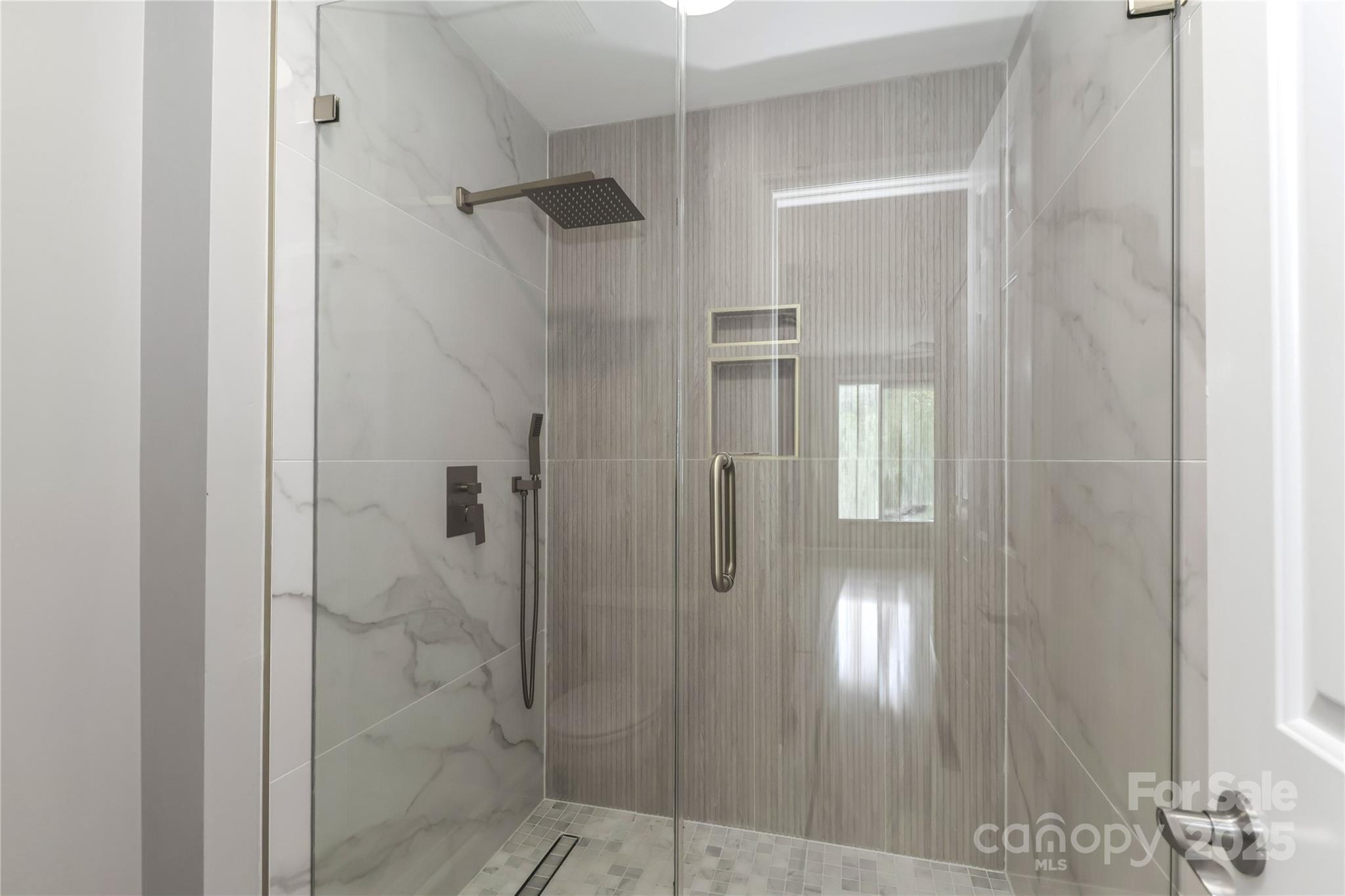 18563 Vineyard Point Lane Cornelius, NC 28031 - Photo 16 of 23 a bathroom with a glass shower door