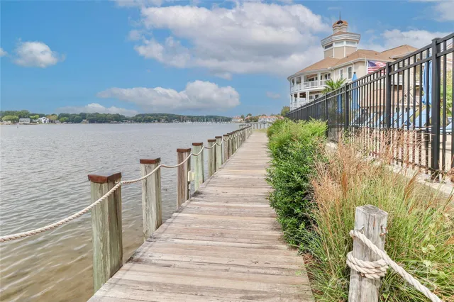 a view of a pathway of a house with wooden bridge
