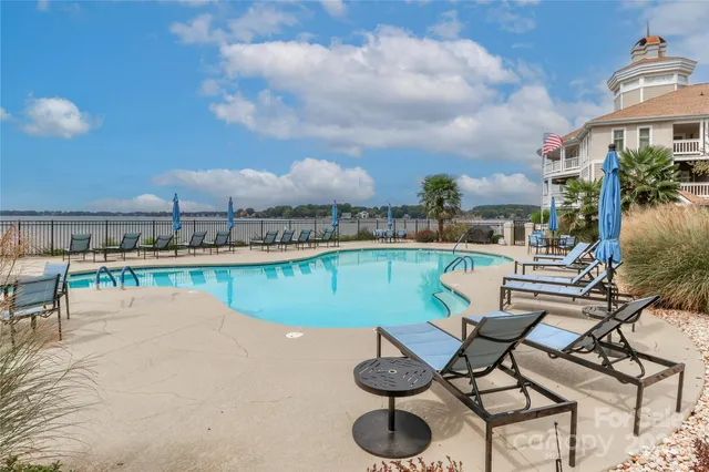 a view of a swimming pool with outdoor seating
