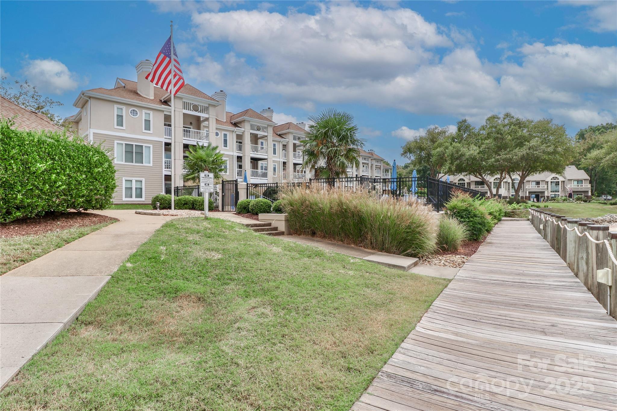 18563 Vineyard Point Lane Cornelius, NC 28031 - Photo 4 of 23 a view of a brick house with a yard and potted plants