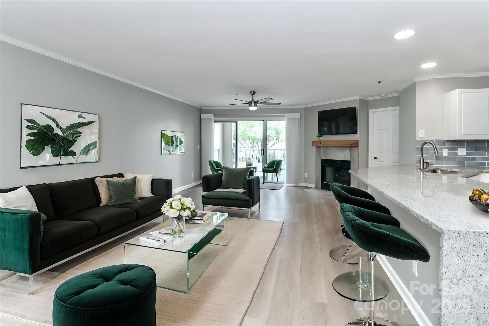 18563 Vineyard Point Lane Cornelius, NC 28031 - Photo 5 of 23 a living room with furniture a fireplace and a flat screen tv