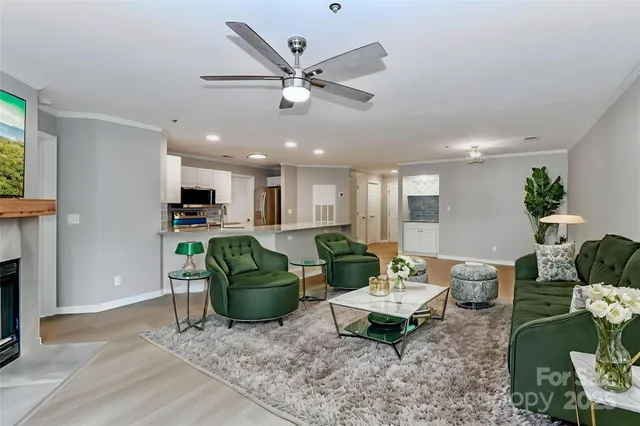 a living room with furniture and kitchen view