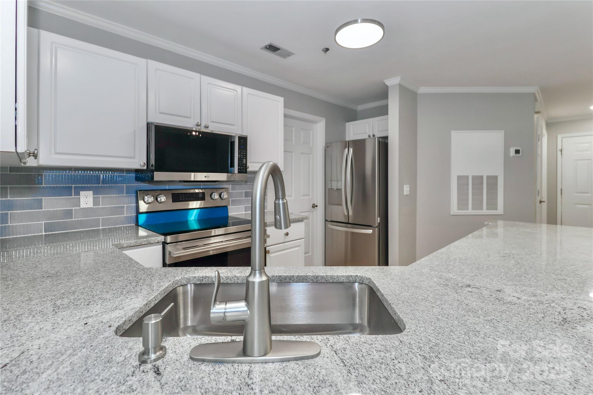 18563 Vineyard Point Lane Cornelius, NC 28031 - Photo 7 of 23 a living room with furniture and a flat screen tv