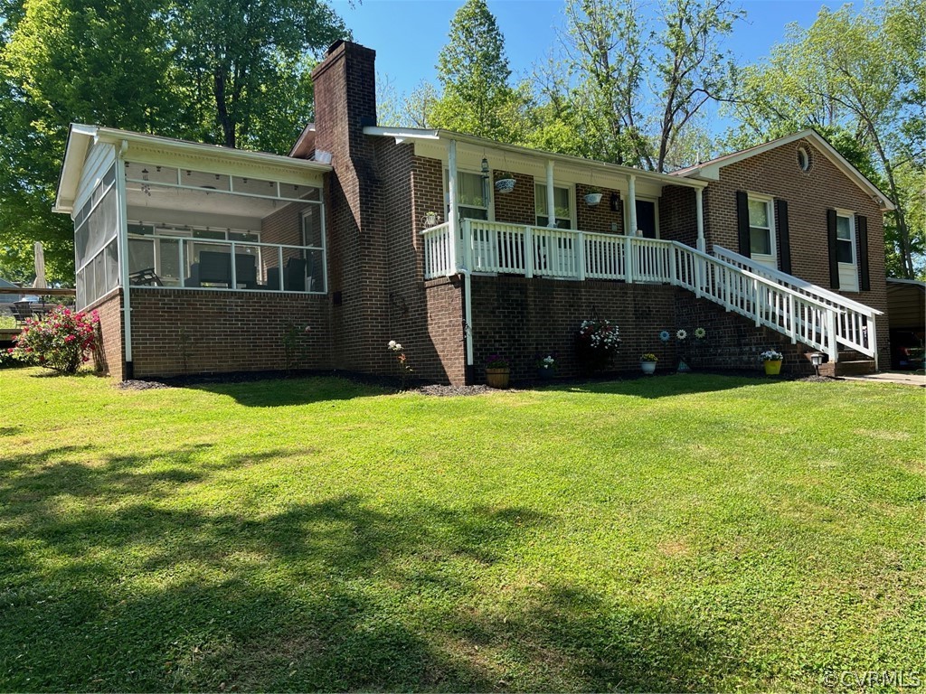 a view of house with yard and green space