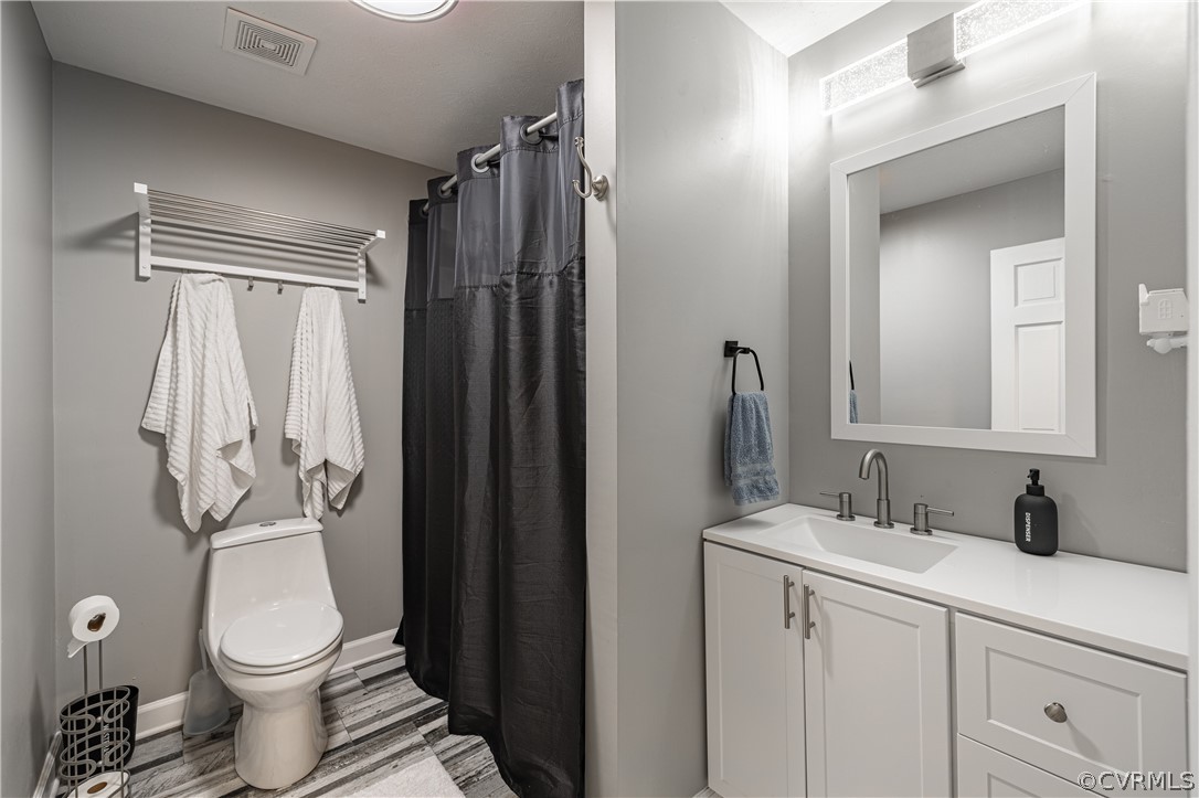 6039 Old Nottoway Road Crewe, VA 23930 - Photo 26 of 46 a bathroom with a toilet a sink and a mirror