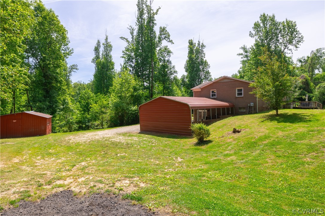 6039 Old Nottoway Road Crewe, VA 23930 - Photo 32 of 46 a yellow house with a big yard and large trees