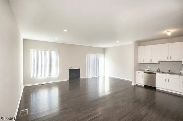 a view of a kitchen with a sink and wooden floor