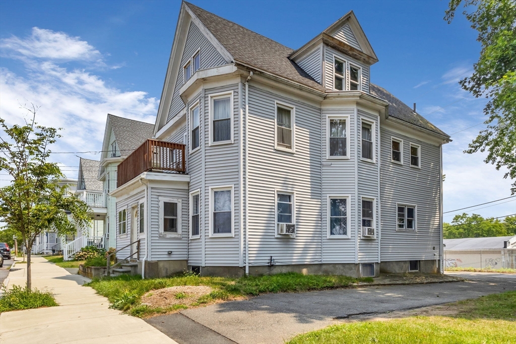 5 Beckford Street, Unit 3 Beverly, MA 01915 - Photo 12 of 15 a front view of a house with a yard and garage