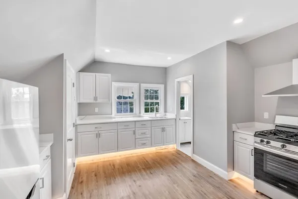 a kitchen with stainless steel appliances granite countertop a stove and a refrigerator