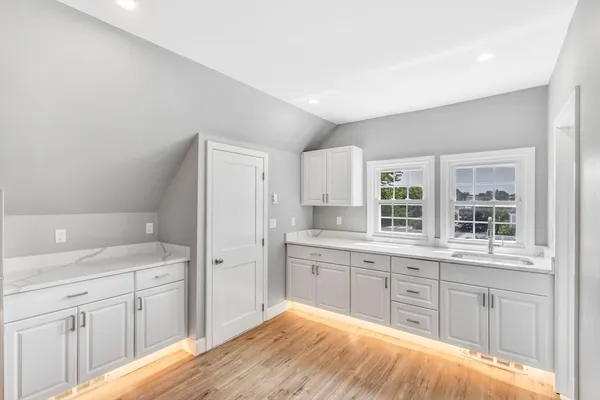 a spacious bathroom with a granite countertop sink mirror and