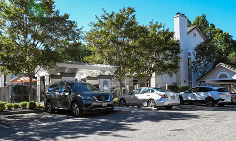 a street view with couple of cars parked on road
