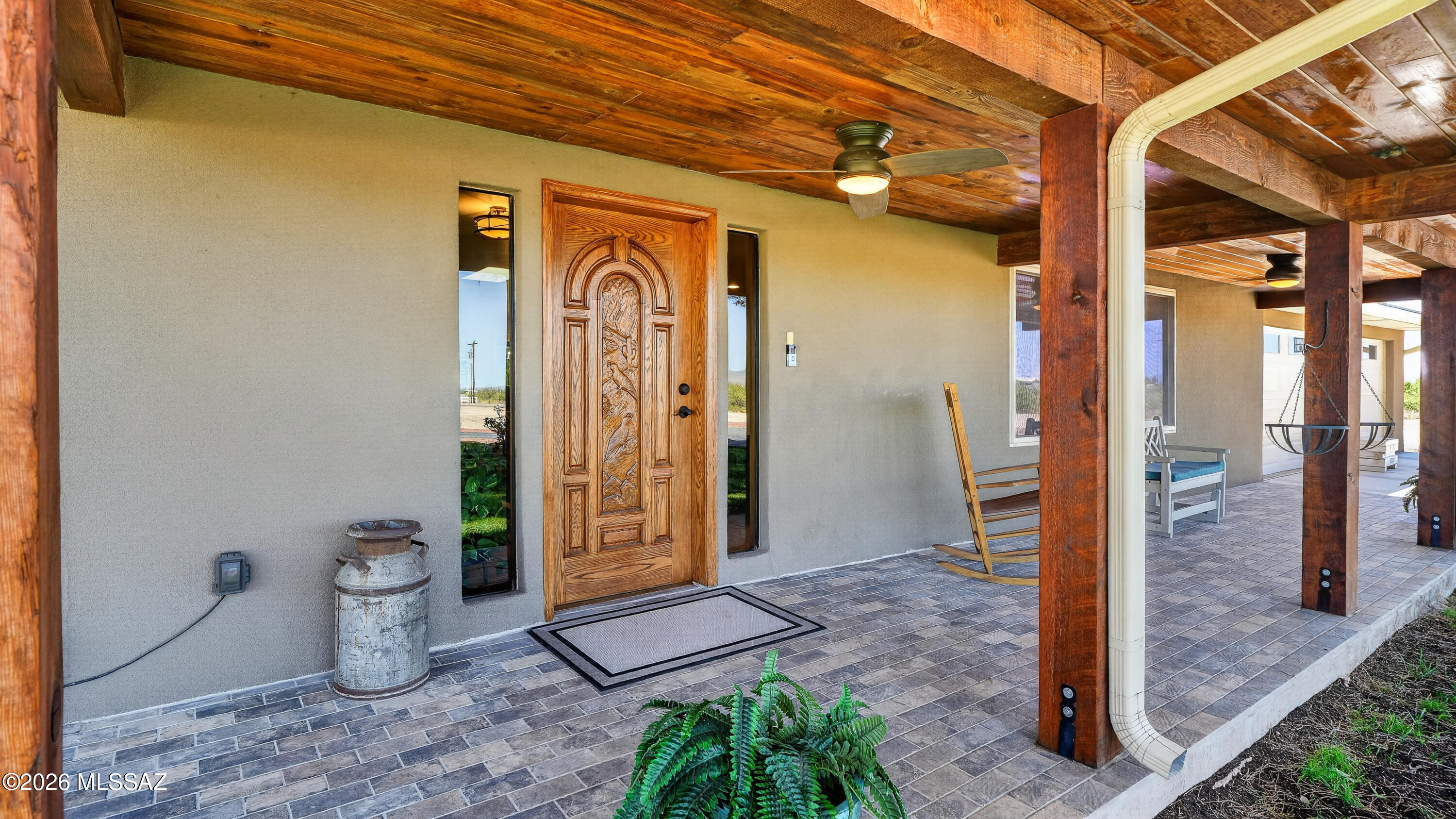 194 Taylor Road Willcox, AZ 85643 - Photo 9 of 54 Inviting covered front porch with tiled flooring, rough-sawn tongue-and-groove wood ceilings, and five 6x6 rough-sawn posts, custom wood front door featuring a hand-carved quail detail, Dual Sidelights, Freshly refinished 6/26