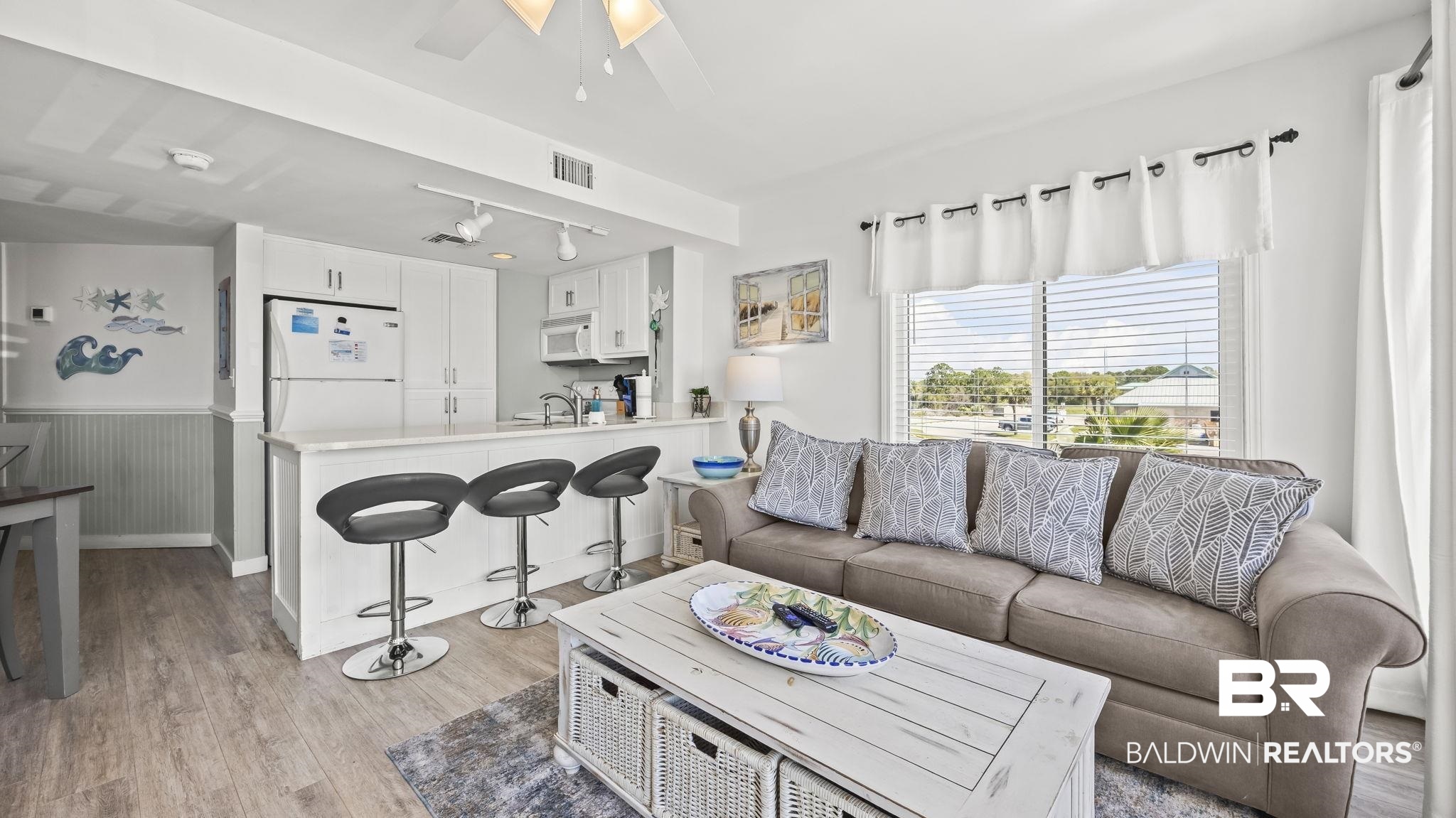 497 Plantation Road, Unit 1247 Gulf Shores, AL 36542 - Photo 3 of 29 Living room featuring light wood finished floors, a ceiling fan, wainscoting, and track lighting