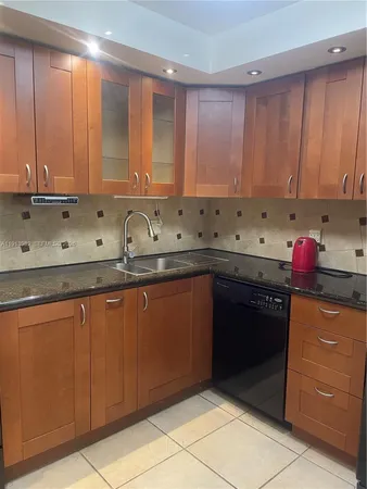 a kitchen with a sink a stove and a microwave