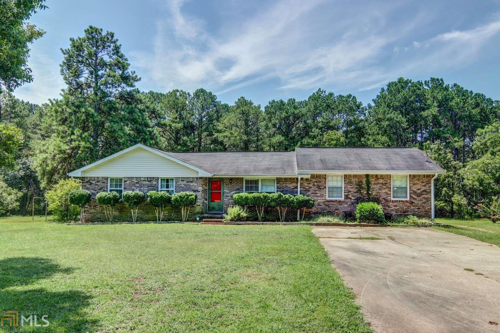 1050 Mote Road Covington, GA 30016 - Photo 1 of 1 a front view of a house with garden