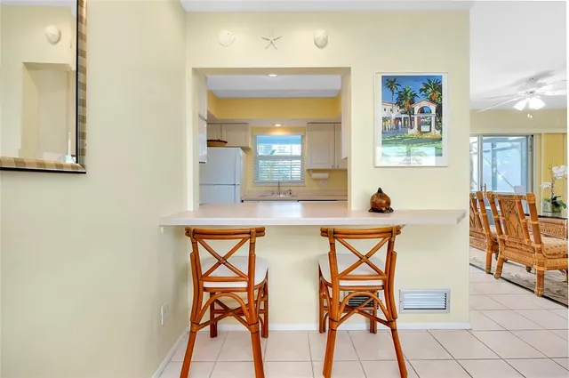a kitchen with a sink cabinets stainless steel appliances and a window