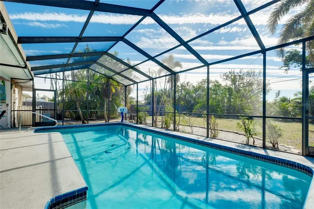 a view of a swimming pool with an outdoor space and seating area