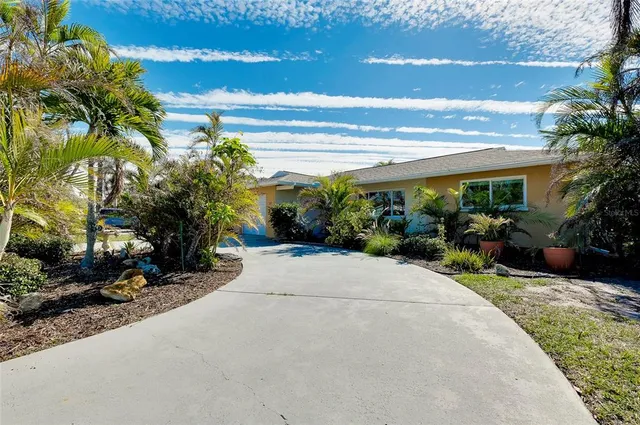 an aerial view of a house with swimming pool and garden