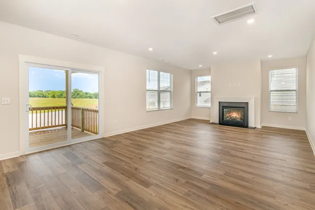 a view of large open kitchen with kitchen island wooden floor and window