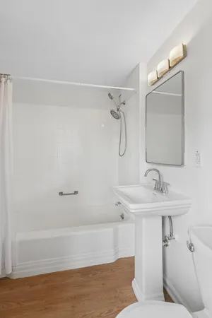 a bathroom with a sink and mirror with toilet