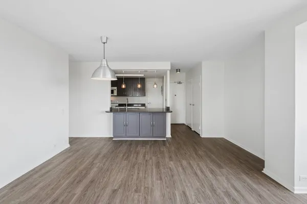 a kitchen with wooden floors and appliances
