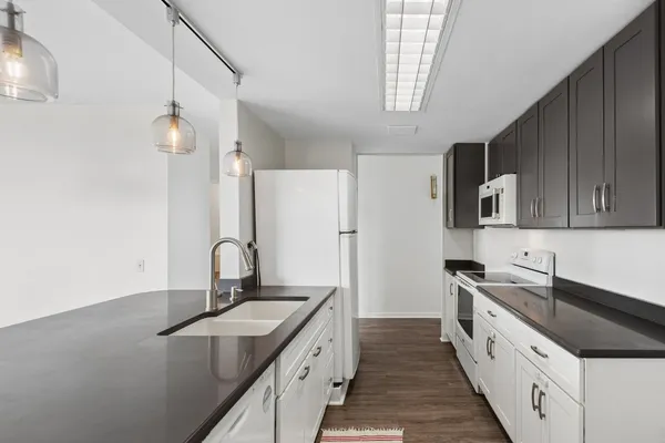 a kitchen with a sink stove and cabinets