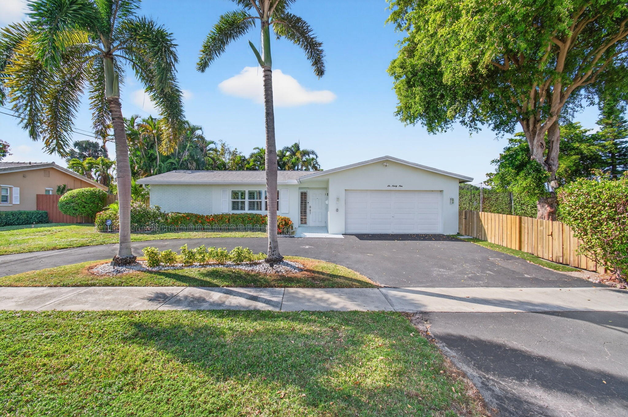 699 Northwest 16th Avenue Boca Raton, FL 33486 - Photo 1 of 32 a front view of a house with garden