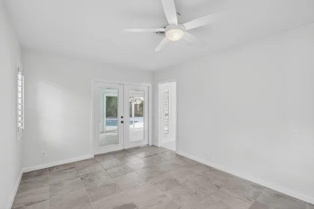 an empty room with a empty space and windows